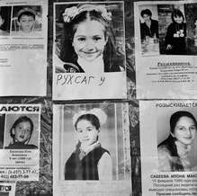 A notice board outside School No. 1 posted photographs of missing students, Beslan, North Ossetia, September 2004